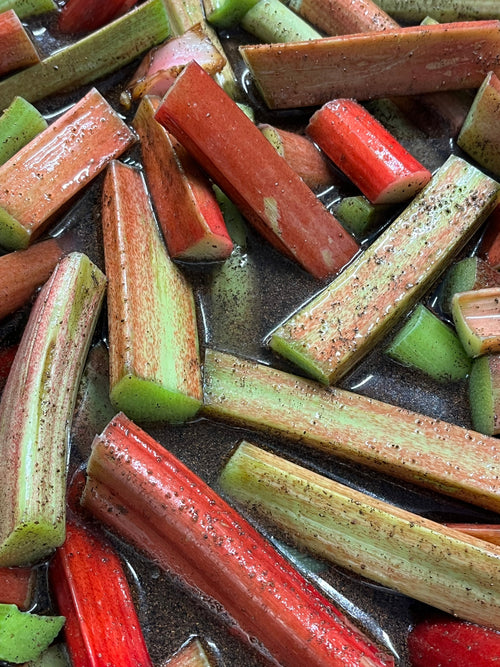 Close-up of sliced rhubarb pieces on a dark surface