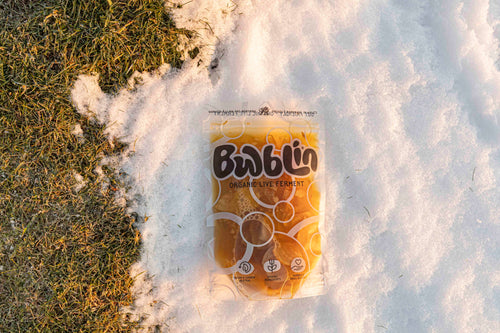 Bwblin probiotic package on snow with grass