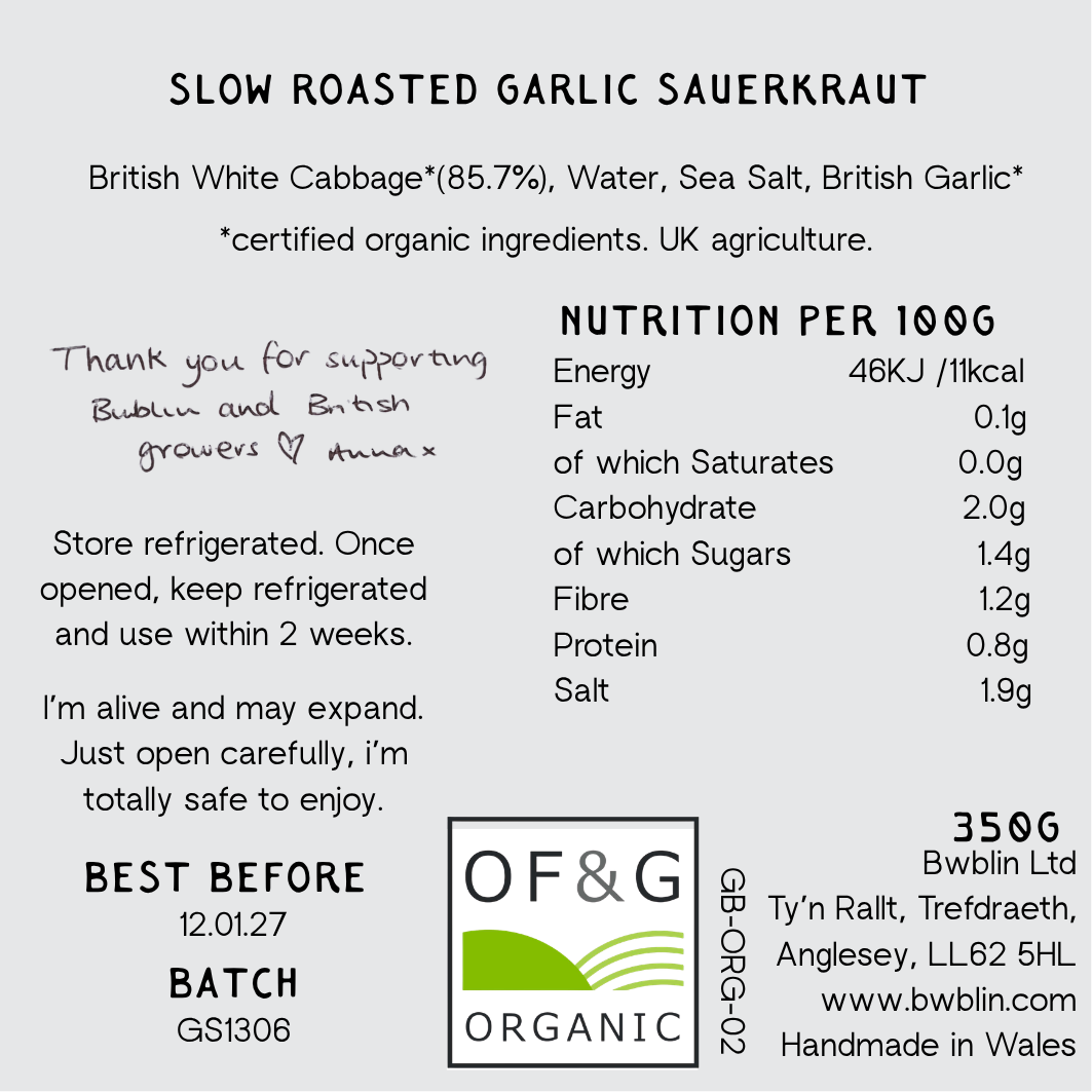 A product information label for Slow Roasted Garlic Sauerkraut, showing ingredients, storage instructions, nutrition per 100g, best before date, batch number, and the OF&G Organic logo on a white background.